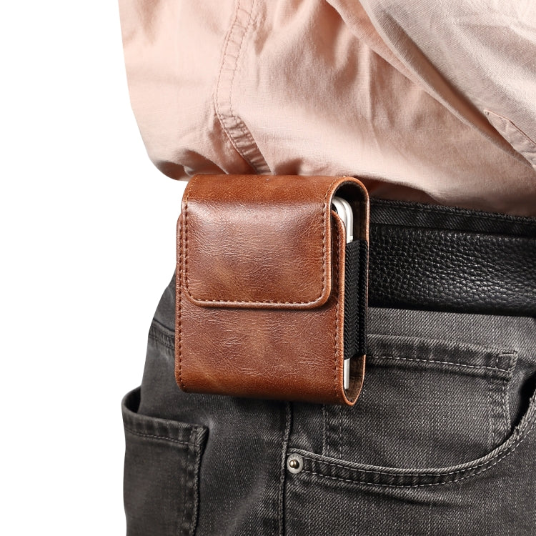 Brown leather waist-mounted phone case on jeans pocket with front flap