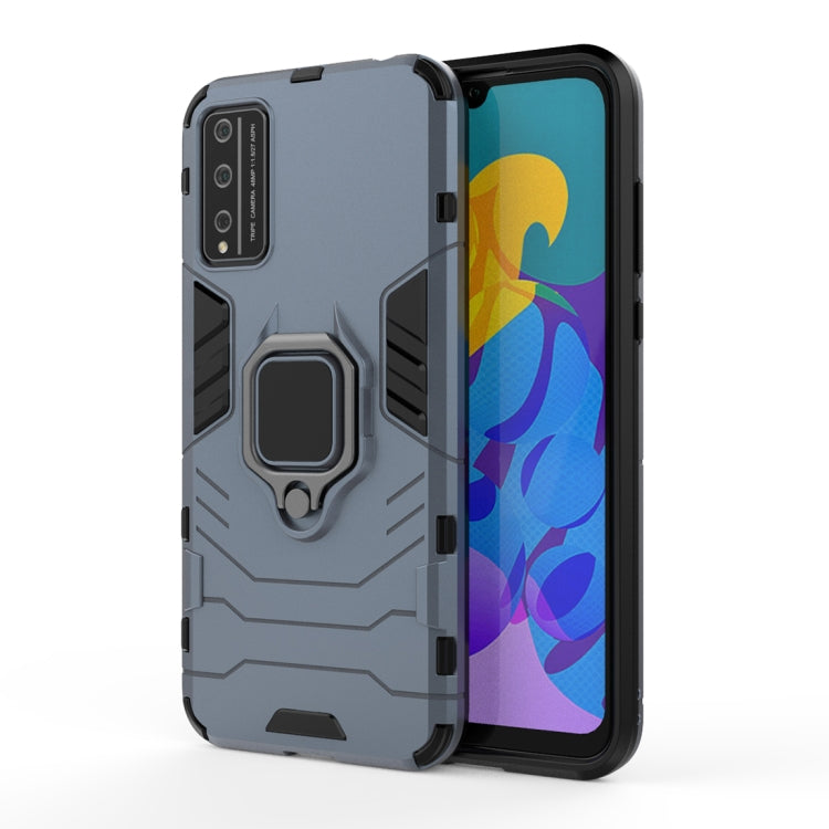 Gray-blue rugged phone case with magnetic ring holder and raised camera area.