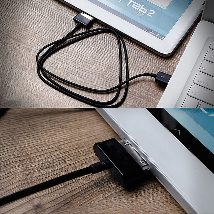 Black USB cable connecting tablets, USB-A plug attached to charging port