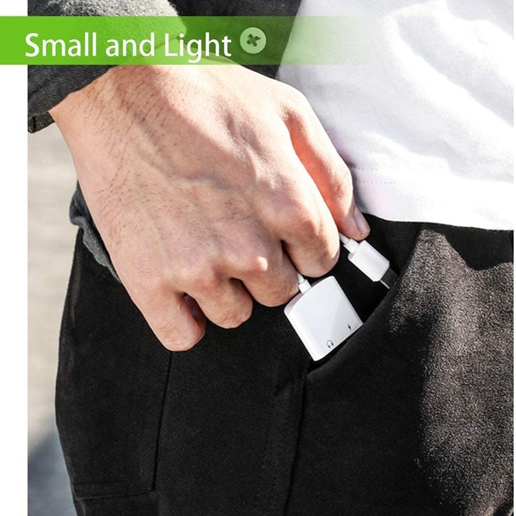 Compact white USB-C to 3.5mm adapter held and plugged into a device