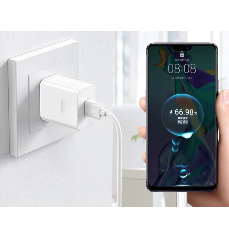 White 66W USB fast-charging travel charger powering a smartphone via USB cable.
