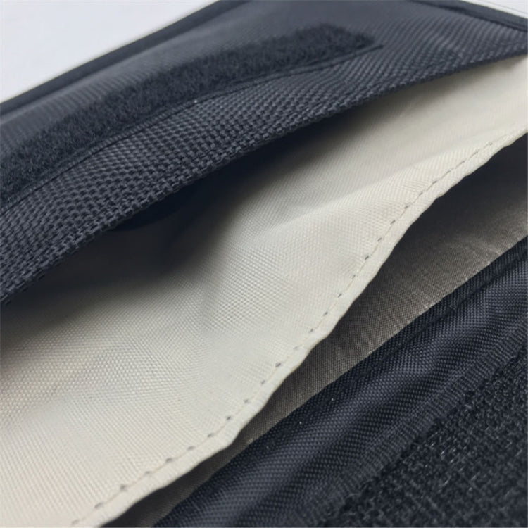Cell phone shielding pouch close-up of dark mesh exterior and beige stitched lining
