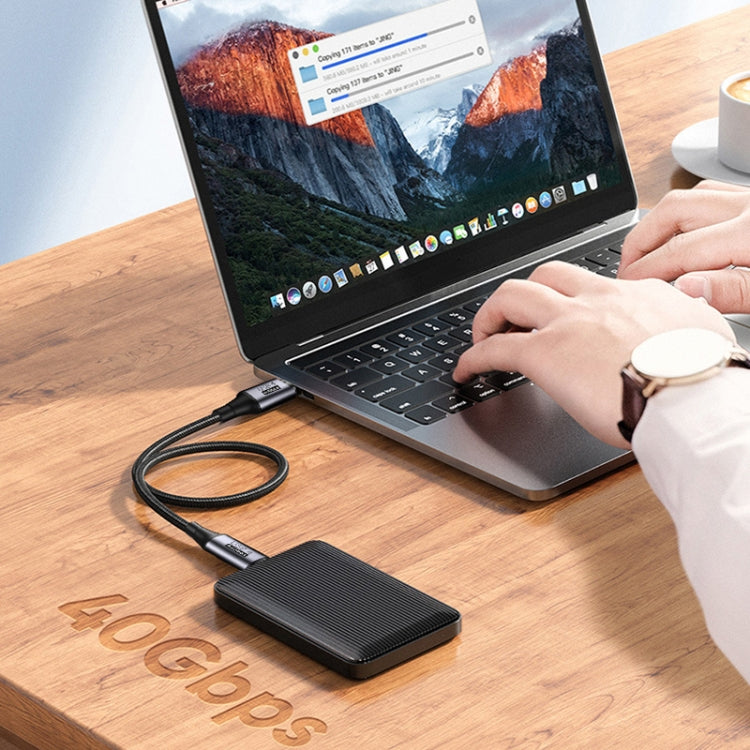 Black nylon-braided Type-C to Type-C fast charging cable connected to a device