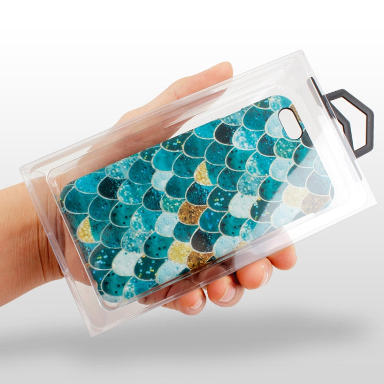 Hand holding clear PVC phone case packaging box with blue patterned case inside