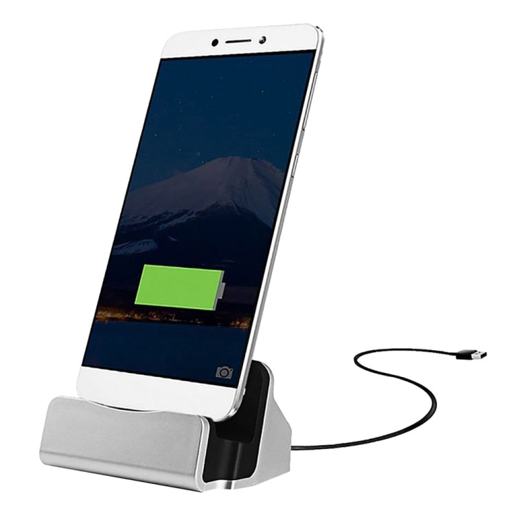 White USB-C charging dock stand with silver base and cable, phone in black cradle