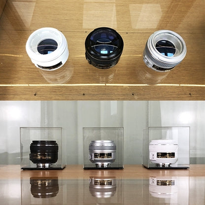 Top view of three fake camera lens models with dark openings and metal rings