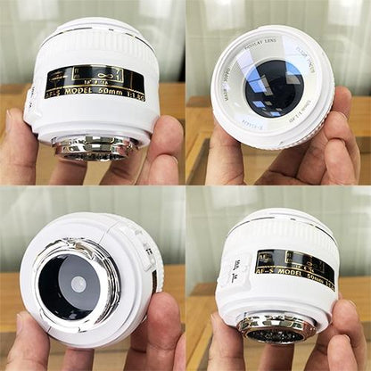 White fake camera lens model held in hand, front and back views