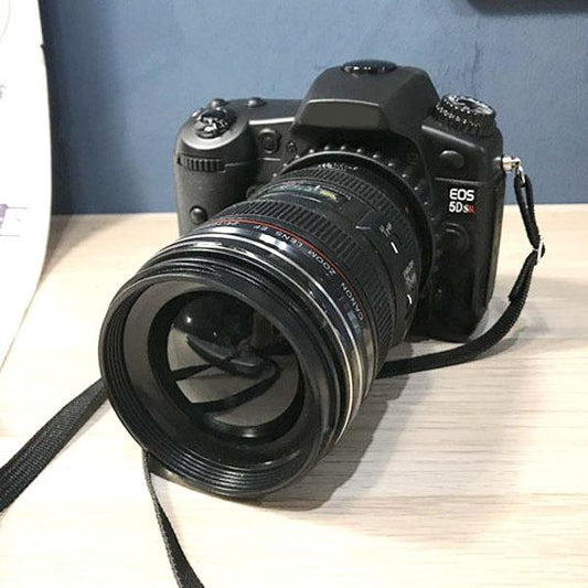 Black dummy DSLR camera prop with attached lens and neck strap