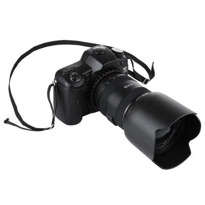 Black fake DSLR camera prop with lens hood and strap.