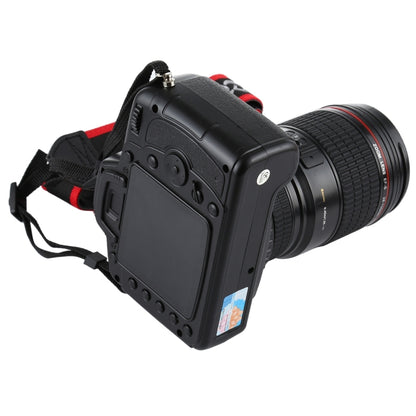 Black DSLR camera prop from rear with textured lens and red shoulder strap
