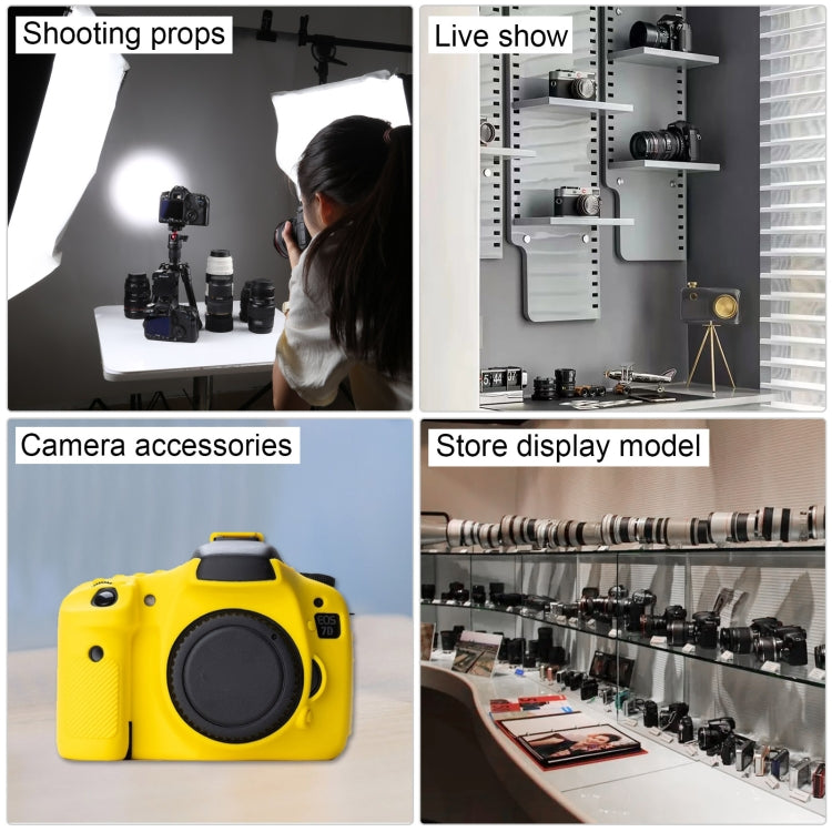 Black DSLR camera prop on display with lens and strap among studio accessories
