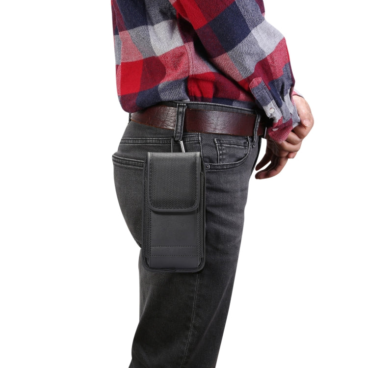 Black vertical waist bag worn at hip with front flap and belt loop