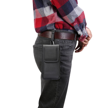 Black vertical waist bag worn at hip with front flap and belt loop