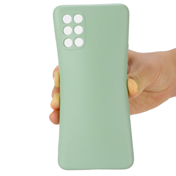 Green liquid silicone phone case held in hand, with camera cutouts