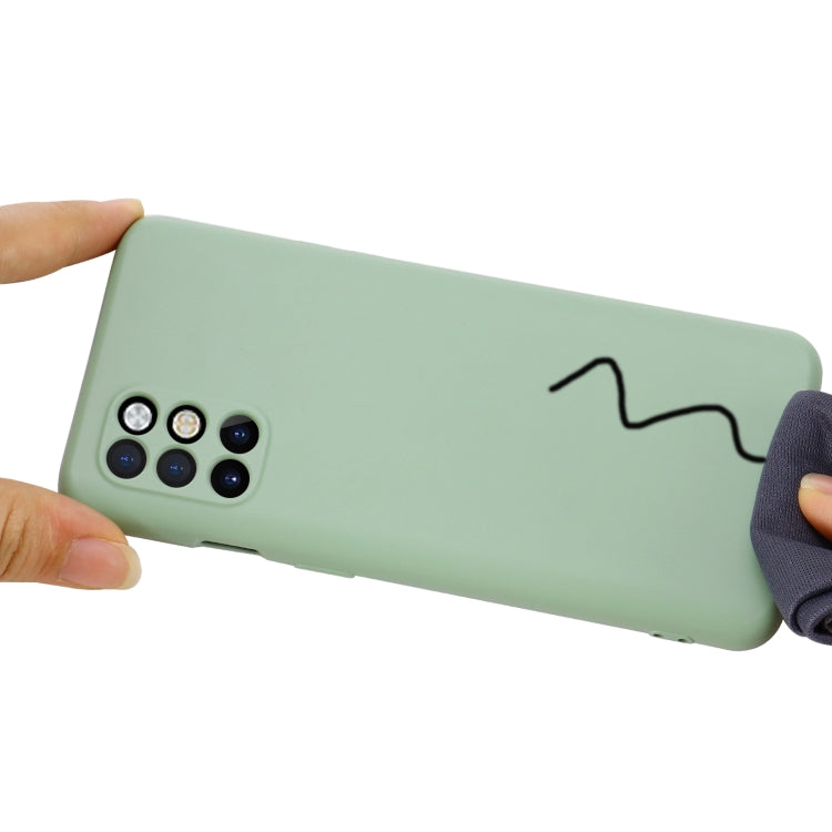 Green silicone phone case with camera cutout and wrist strap attachment