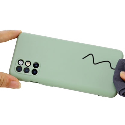 Green silicone phone case with camera cutout and wrist strap attachment