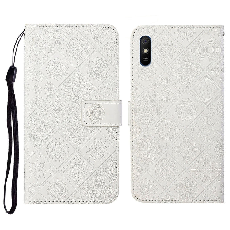 White embossed flip leather phone case with card holder, wrist strap, and cutout for camera