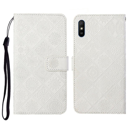 White embossed flip leather phone case with card holder, wrist strap, and cutout for camera