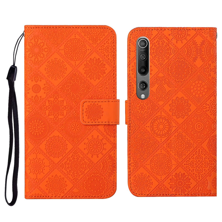 Orange embossed flip leather wallet phone case with card slots and wrist lanyard