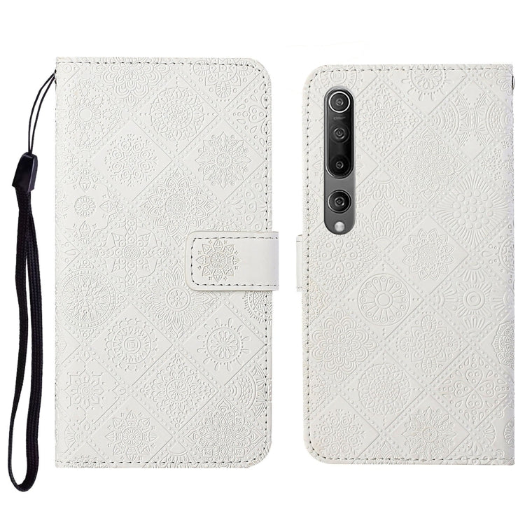 White embossed flip leather wallet phone case with card slots and wrist lanyard
