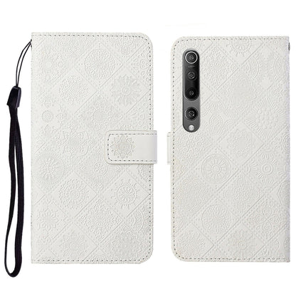 White embossed flip leather wallet phone case with card slots and wrist lanyard