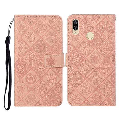 Pink embossed folio leather phone case with flip cover, card slot, and wrist strap