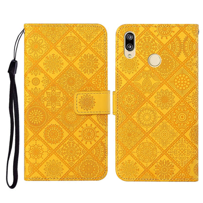 Yellow embossed folio leather phone case with flip cover, card slot, and wrist strap