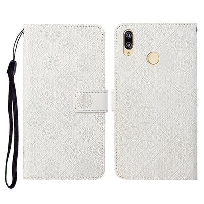 White embossed folio leather phone case with flip cover, card slot, and wrist strap