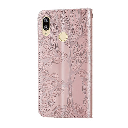 Rose gold embossed leather back flip phone case with camera cutouts and wrist strap