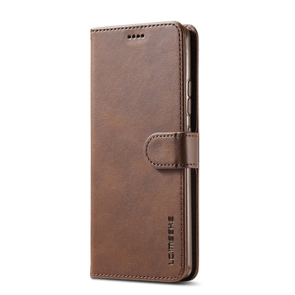 Brown leather flip phone case with front cover and card-slot strap; phone back ports visible.