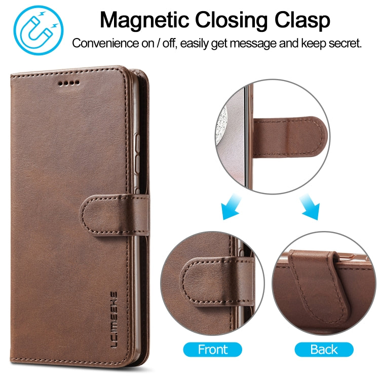 Brown leather flip phone case with magnetic clasp closure; front flap and strap detail.