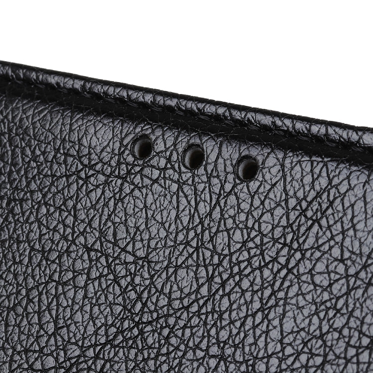 Close-up of black nappa leather texture with perforation details along the top edge