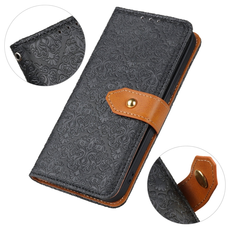 Black embossed floral PU leather flip phone wallet case with copper buckle clasp close-up