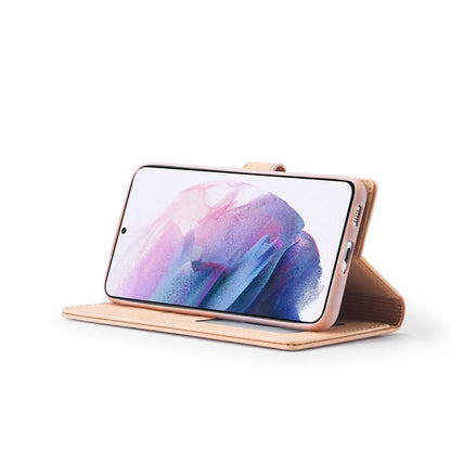 Rose gold leather flip phone case used as a stand with phone screen facing up