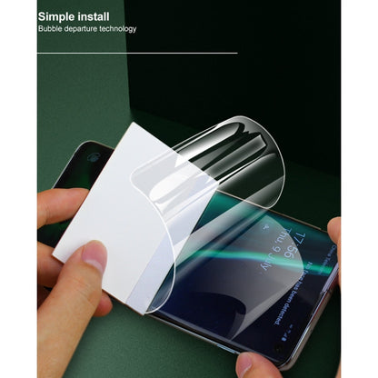 Hand applying curved hydrogel screen protector film to smartphone