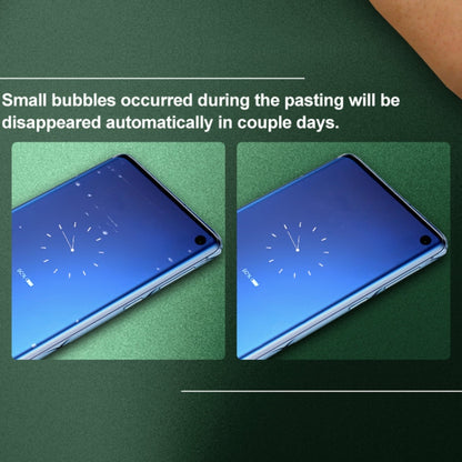 Smartphone with curved hydrogel screen protector film; small bubbles show during pasting