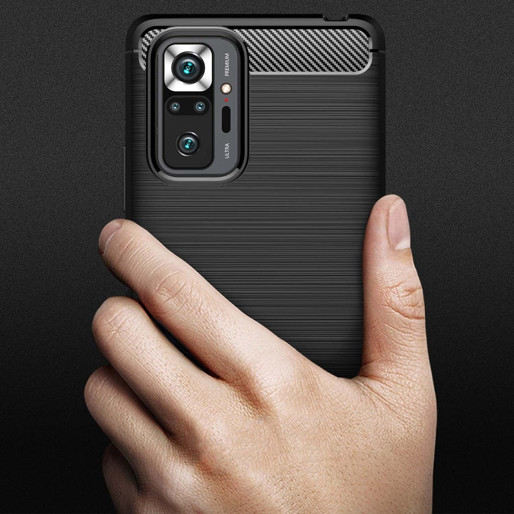 Black brushed-texture TPU phone case with carbon-fiber panel, held in hand for Xiaomi Redmi Note 10 Pro