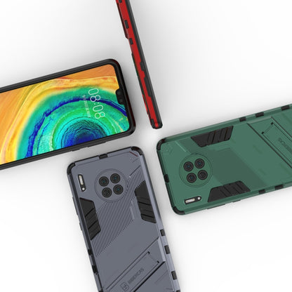 Rugged phone case in dark tones with stand and camera bump protection, corner angles