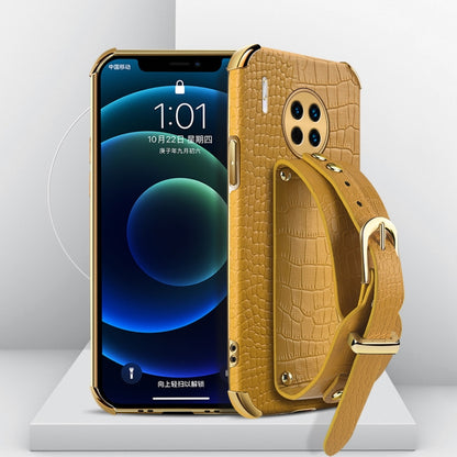 Yellow crocodile-pattern TPU phone case with wrist strap for Huawei, gold-tone accents.