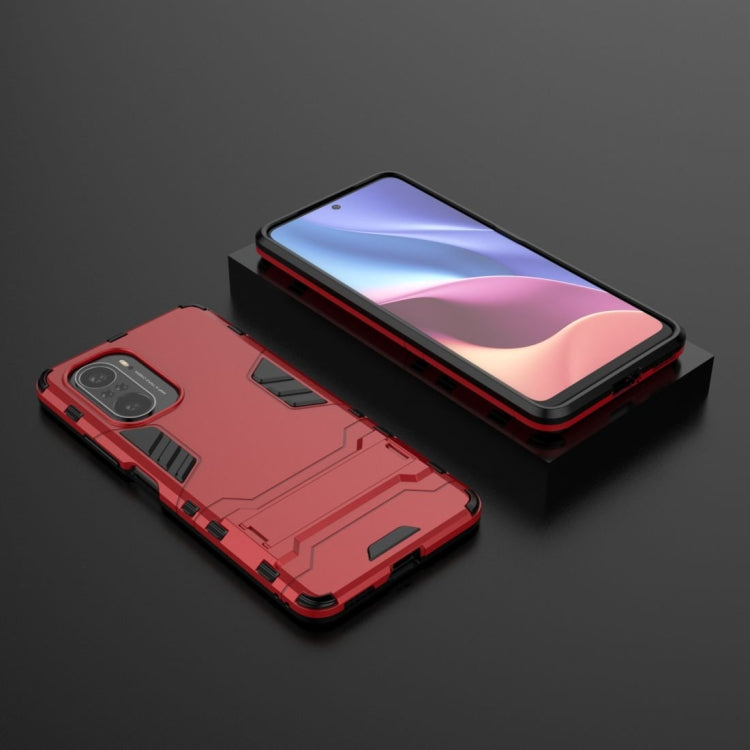 Shockproof red protective phone case with built-in holder and camera openings