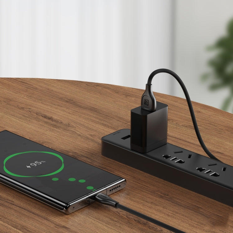 Black Remax Lesu Pro 8-pin charging cable plugged into a power outlet