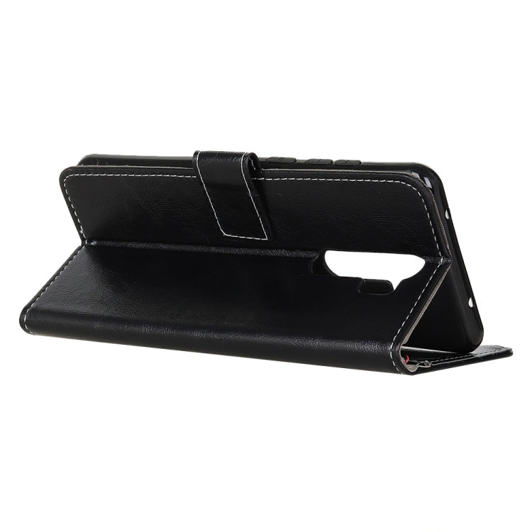 Black flip leather wallet case folded open as a stand for phone