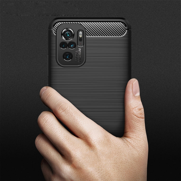 Black brushed carbon fiber TPU smartphone case back with camera cutout; held by hand