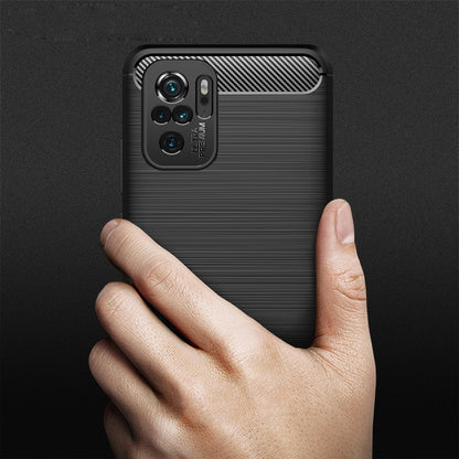 Black brushed carbon fiber TPU smartphone case back with camera cutout; held by hand