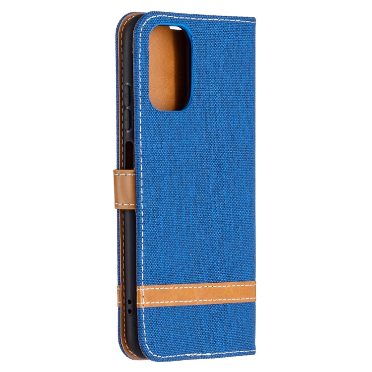 Blue denim-texture leather wallet phone case with side cutout and tan stitched strap