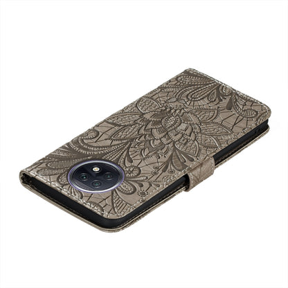 Embossed leather phone wallet case with floral lace pattern and camera cutout detail