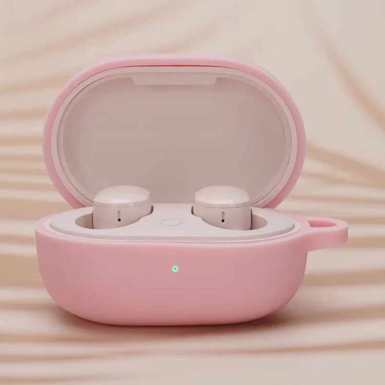 Pink silicone earphone protective case with open lid and two white earbuds inside
