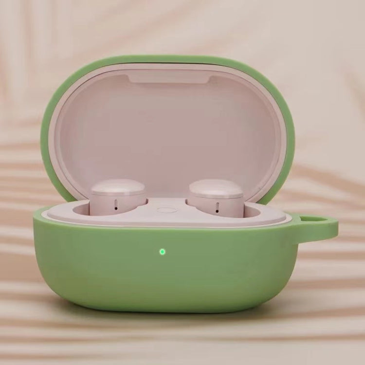 Green silicone earphone protective case with open lid and two white earbuds inside