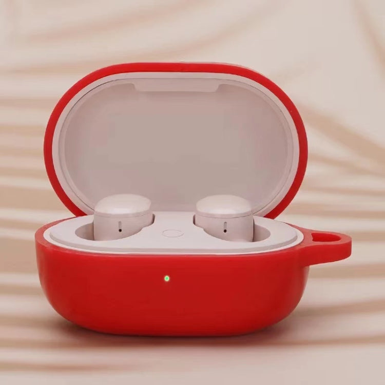 Red silicone earphone protective case with open lid and two white earbuds inside