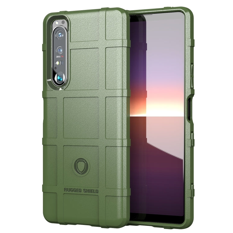 Rugged shockproof TPU phone case, olive green with textured grip, camera openings, and shield logo